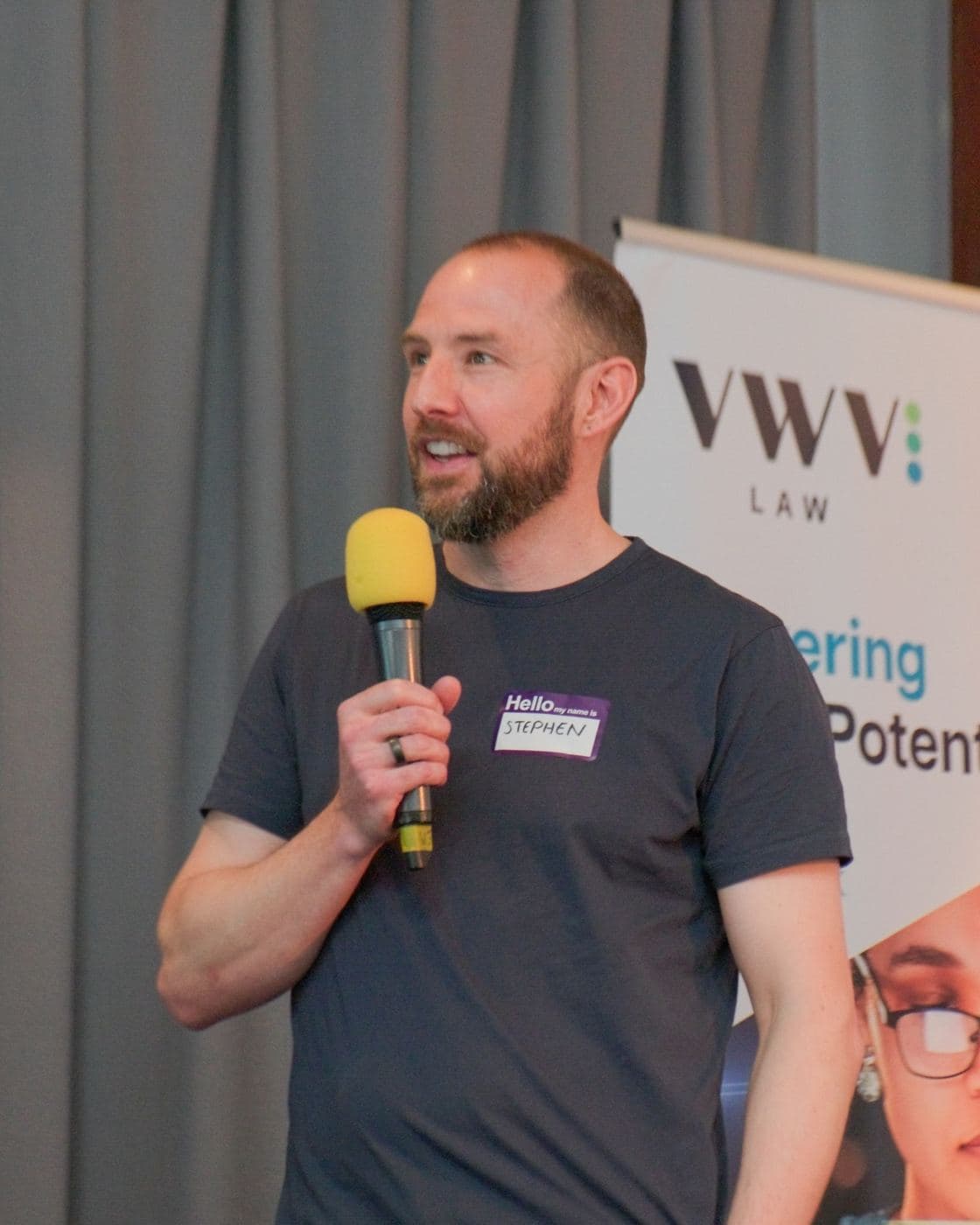 Stephen Honight hosting with a microphone