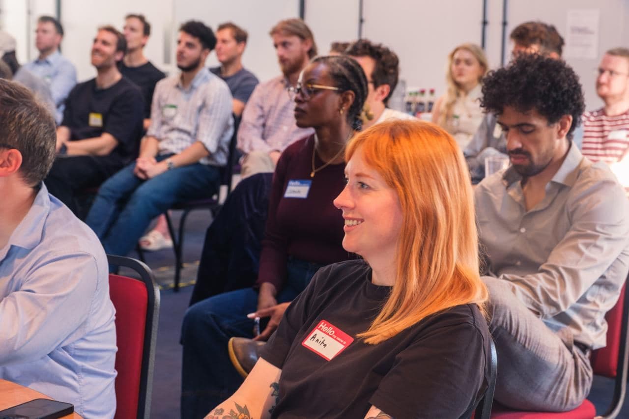 Attendees smiling during a talk